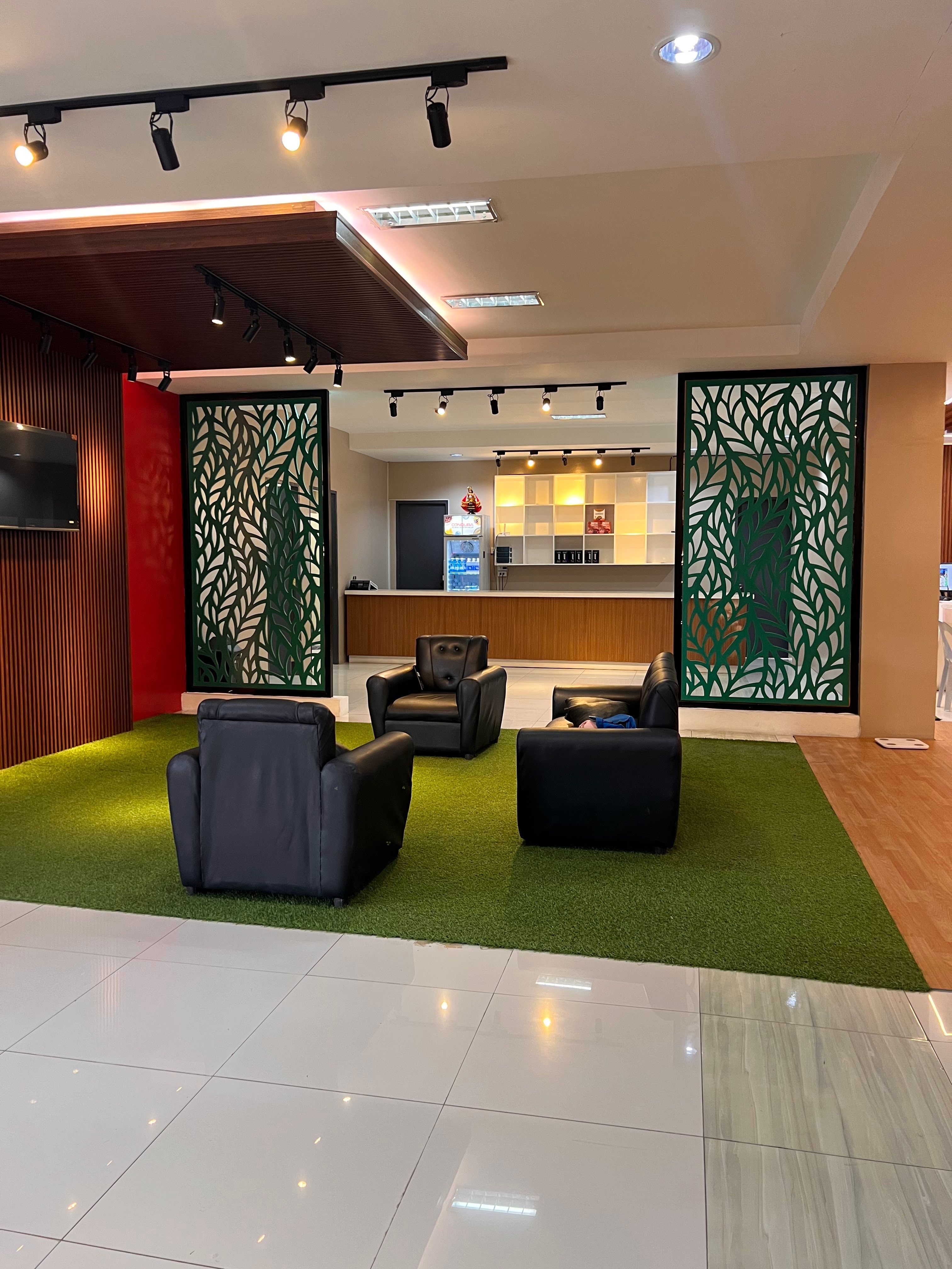 Member lounge with black leather chairs on turf