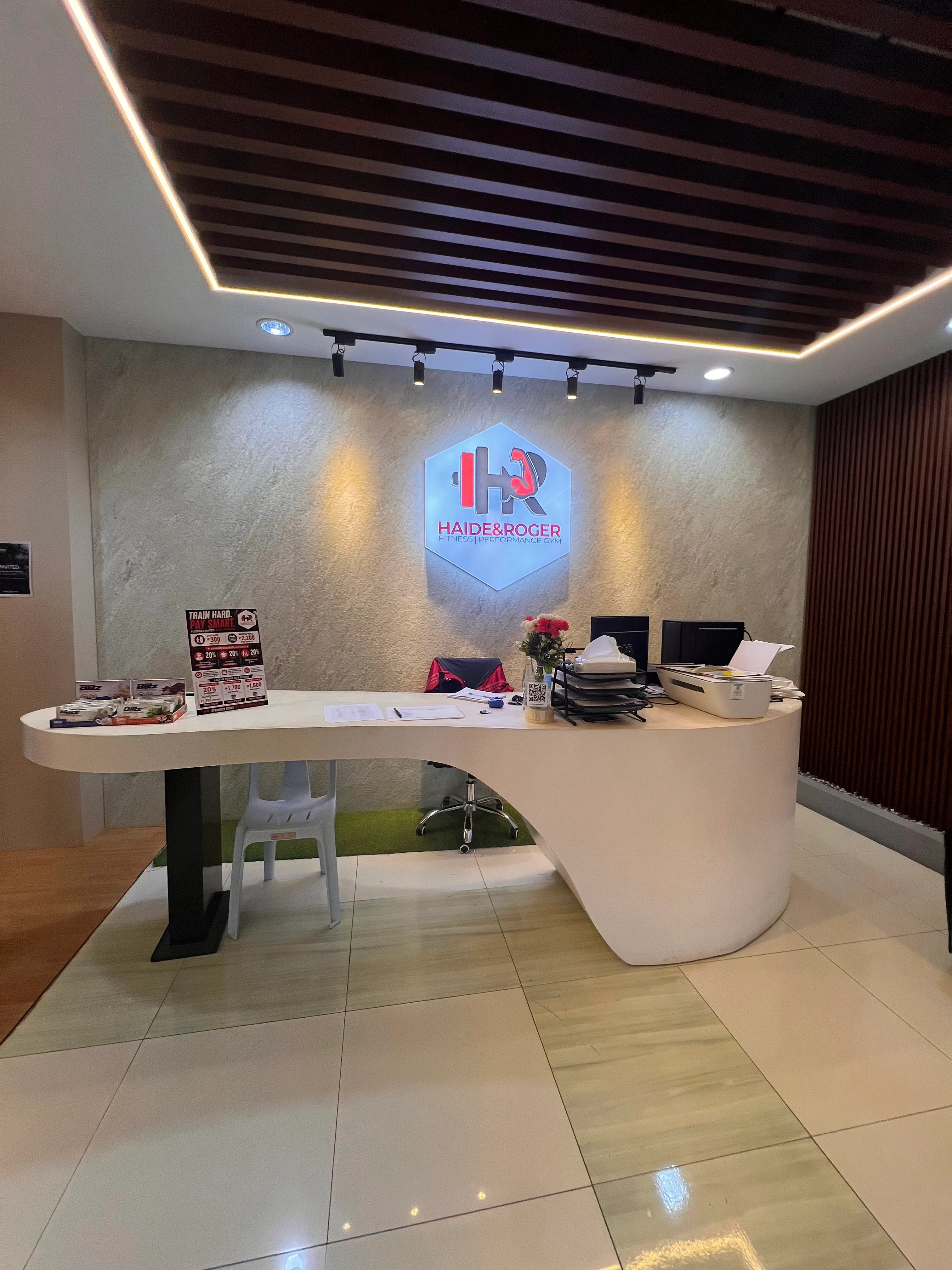Reception with the lit H&R logo wall