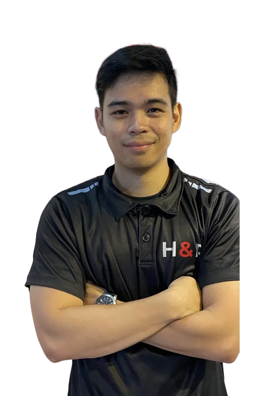 Coach Nhoel with arms crossed in an H&R polo