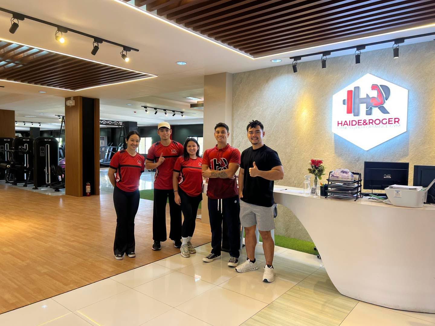 The H&R coaching team in red shirts at the front desk